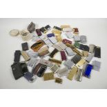 A large collection of cigarette lighters, mainly Ronson