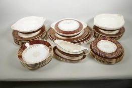 A vintage J&G Meakin red and gilt 'Sol' pattern dinner service with four oval platters, lidded