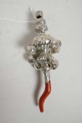A white metal and coral baby's rattle/whistle, 5½" long