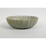 A Chinese celadon glazed porcelain bowl of lotus form, with a lobed rim, 8" diameter