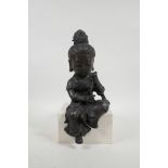 A Chinese bronze shelf sitting figure of a large headed Quan Yin, impressed 4 character mark
