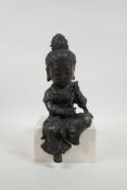 A Chinese bronze shelf sitting figure of a large headed Quan Yin, impressed 4 character mark