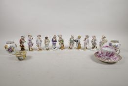 Ten continental hard paste porcelain figures depicting the months of the year, crossed sword mark to