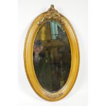 A carved Victorian wood and gilt mirror with hanging brass chain to the reverse, 22" long x 13" wide