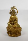 A Chinese gilt bronze of Quan Yin seated on a lotus throne, 12" high, A/F crack to halo