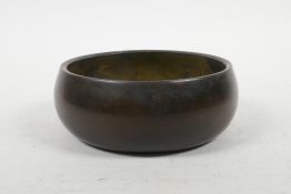A Chinese bronze Buddhist singing bowl, impressed seal mark to base, 5½" diameter
