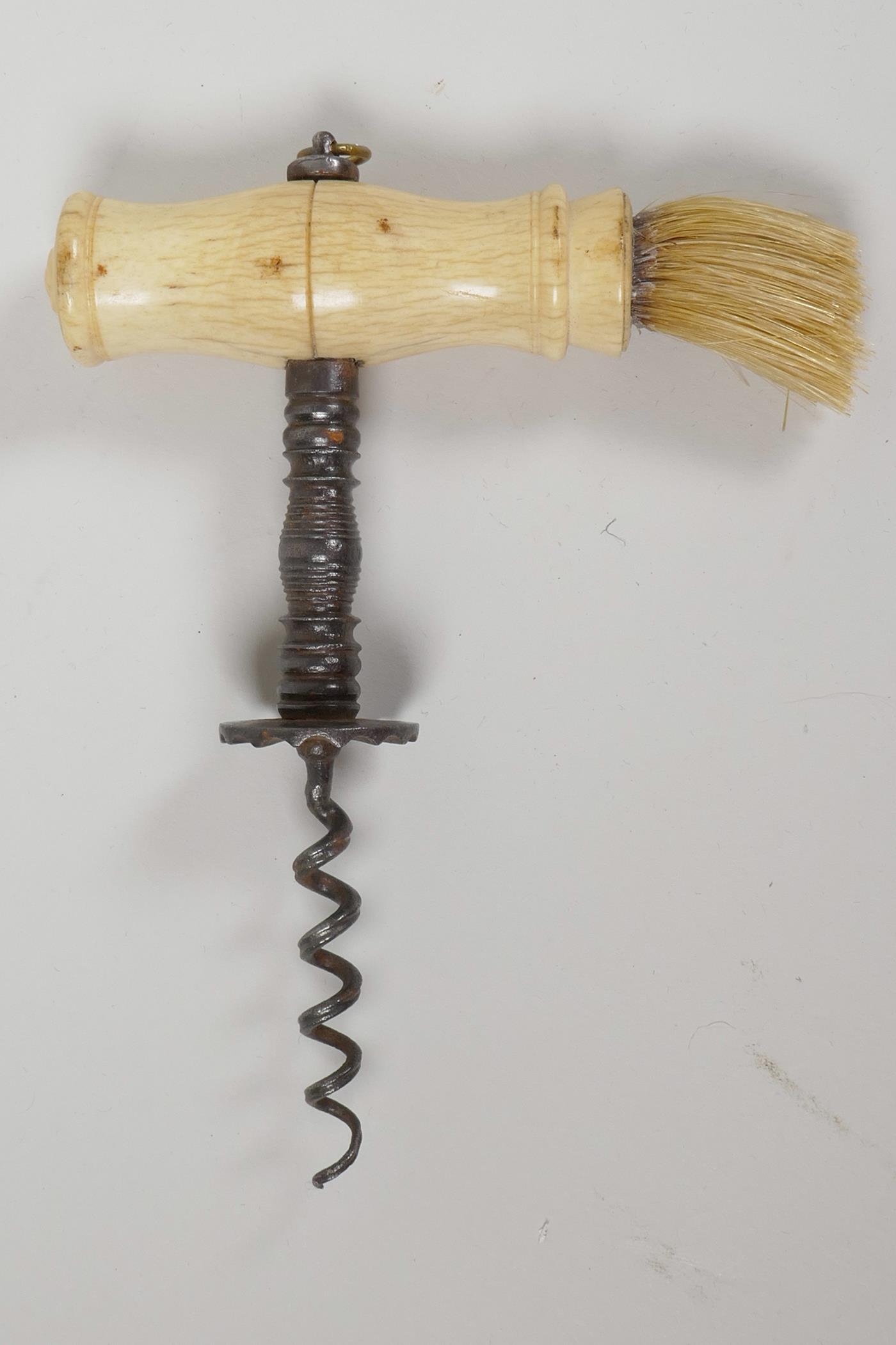 An antique double helix steel corkscrew with bone handle and hair brush, 6" long