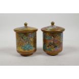 A pair of Japanese Satsuma cylinder pots and covers, decorated with figures, seal mark to base, 4"