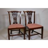 A pair of C18th/C19th mahogany Chippendale side chairs, with pierced Gothic splats, raised on square