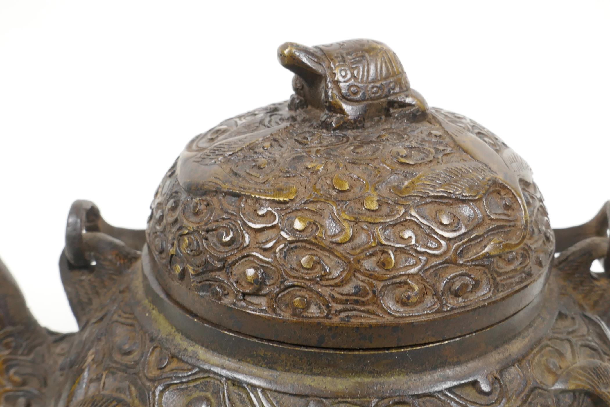 A Chinese bronze teapot with raised decoration of cranes in flight, four character mark to base, 5½" - Image 2 of 6