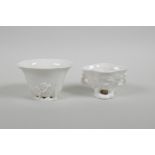 Two blanc de chine porcelain libation cups with floral decoration, largest 2½" high