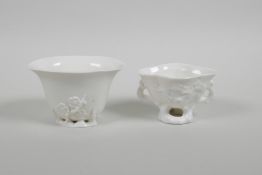 Two blanc de chine porcelain libation cups with floral decoration, largest 2½" high