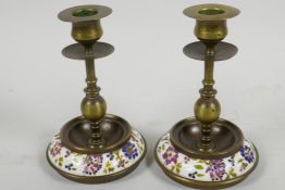 A pair of brass candlesticks with inset Zsolnay style porcelain bases, 6" high