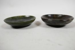 A carved Chinese spinach jade shallow bowl and a carved serpentine shallow bowl, 3¼? diameter