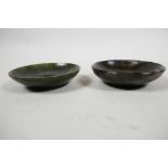 A carved Chinese spinach jade shallow bowl and a carved serpentine shallow bowl, 3¼? diameter