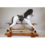 A large dappled painted pine rocking horse, maker's plaque affixed to base, 'Sunrise horses,