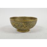 A Chinese bronze bowl with raised and chased dragon and phoenix decoration, six character mark to