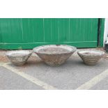 A pair of 1970s concrete conical planters and another larger, 31" diameter largest