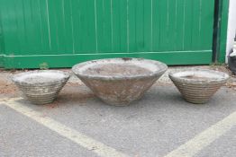 A pair of 1970s concrete conical planters and another larger, 31" diameter largest
