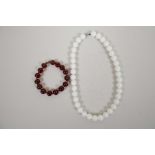 A honey amber style bead bracelet, and a white ceramic bead necklace, largest 17"
