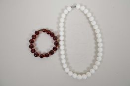 A honey amber style bead bracelet, and a white ceramic bead necklace, largest 17"