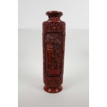 A cinnabar lacquer style sleeve vase with decorative panels depicting objects of virtue, seal mark
