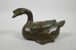 An oriental bronze box and cover in the form of a duck, 5½" long