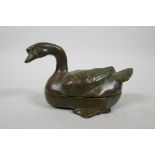 An oriental bronze box and cover in the form of a duck, 5½" long