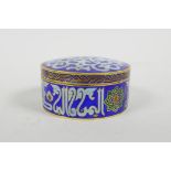 An Islamic cloisonne style enamel box and cover, 3" diameter