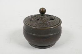 A Chinese bronze censer with a pierced cover decorated with a dragon, marked to base, 3" diameter