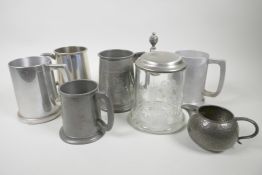 Five pewter tankards, a pewter cream jug and an engraved glass tankard with pewter lid, 6½" high (7)