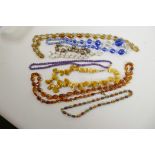 A butterscotch amber natural bead necklace, 18" long, together with an amethyst bead necklace, 20"