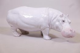 A glazed terracotta hippopotamus, 33" long, repair to front foot
