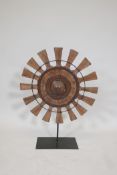 A teak and wrought metal wheel sculpture, 21½" diameter