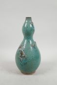 A Chinese green dapple glazed pottery double gourd vase with applied frog decoration, 9½" high