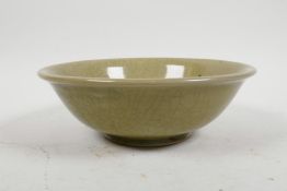A Chinese olive crackle glazed pottery bowl with underglaze lotus flower decoration, character marks