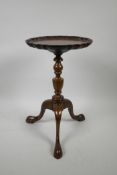 A Victorian mahogany wine table on a turned column and tripod supports, with a pie-crust top, A/F