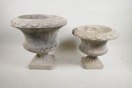 A concrete garden urn and another smaller, largest 11½" high, 12" diameter