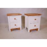 A pair of painted pine two drawer bedside chests, 14" x 20" x 25"