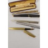 A Waterman gilt cased fountain pen with 18ct gold nib, an unmarked vintage fountain pen, another