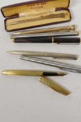 A Waterman gilt cased fountain pen with 18ct gold nib, an unmarked vintage fountain pen, another