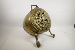 A Victorian brass barrel shaped coal scuttle on paw feet, with pierced decoration, 15" long x 17"