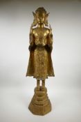A large gilt bronze Thai Buddha, missing finial, 33½" high