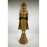 A large gilt bronze Thai Buddha, missing finial, 33½" high