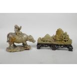 A Chinese soapstone carving of a child riding a buffalo, together with another similar carved