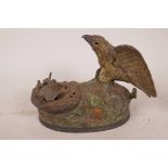 A vintage American cast iron eagle and eaglette mechanical money box with chirp, designed by Charles