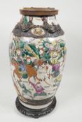 A C19th Chinese porcelain crackleware vase decorated with warriors in bright enamels and raised