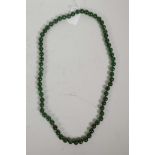A string of dark green jade beads, 31" long