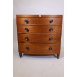 A veneered bowfront chest of four graduated drawers on turned feet, 36" x 21", 37" high