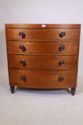 A veneered bowfront chest of four graduated drawers on turned feet, 36" x 21", 37" high